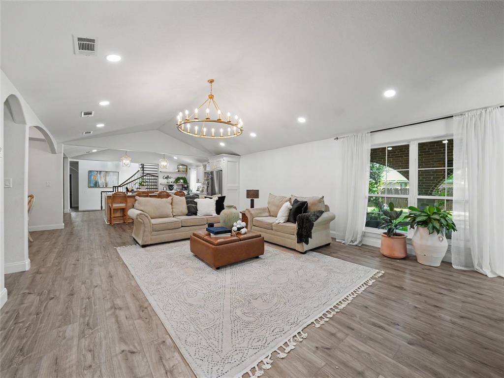 6701 Nauert Road Forest Hill, TX 76140 - Photo 5 of 40 Spacious living area featuring wood-finish flooring, recessed lighting, and a prominent chandelier
