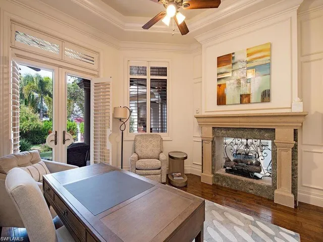 a living room with furniture a fireplace and windows