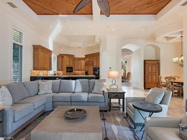a living room with furniture and kitchen view