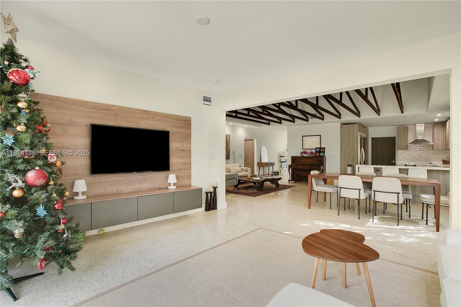 9008 Dickens Avenue Surfside, FL 33154 - Photo 12 of 29 a living room with furniture a flowers and a flat screen tv