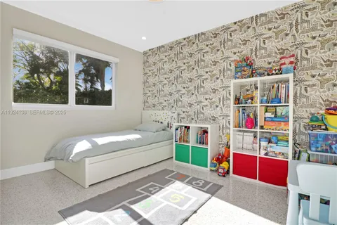 a living room with baby crib and furniture