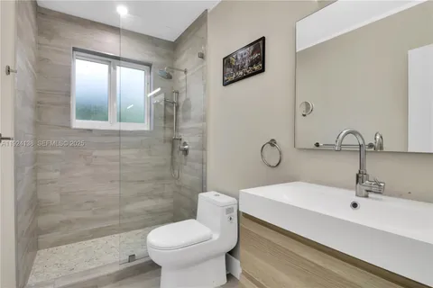 a bathroom with a sink toilet and shower