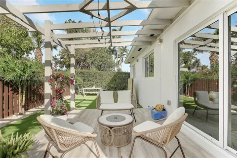 a view of a patio with table and chairs and potted plants