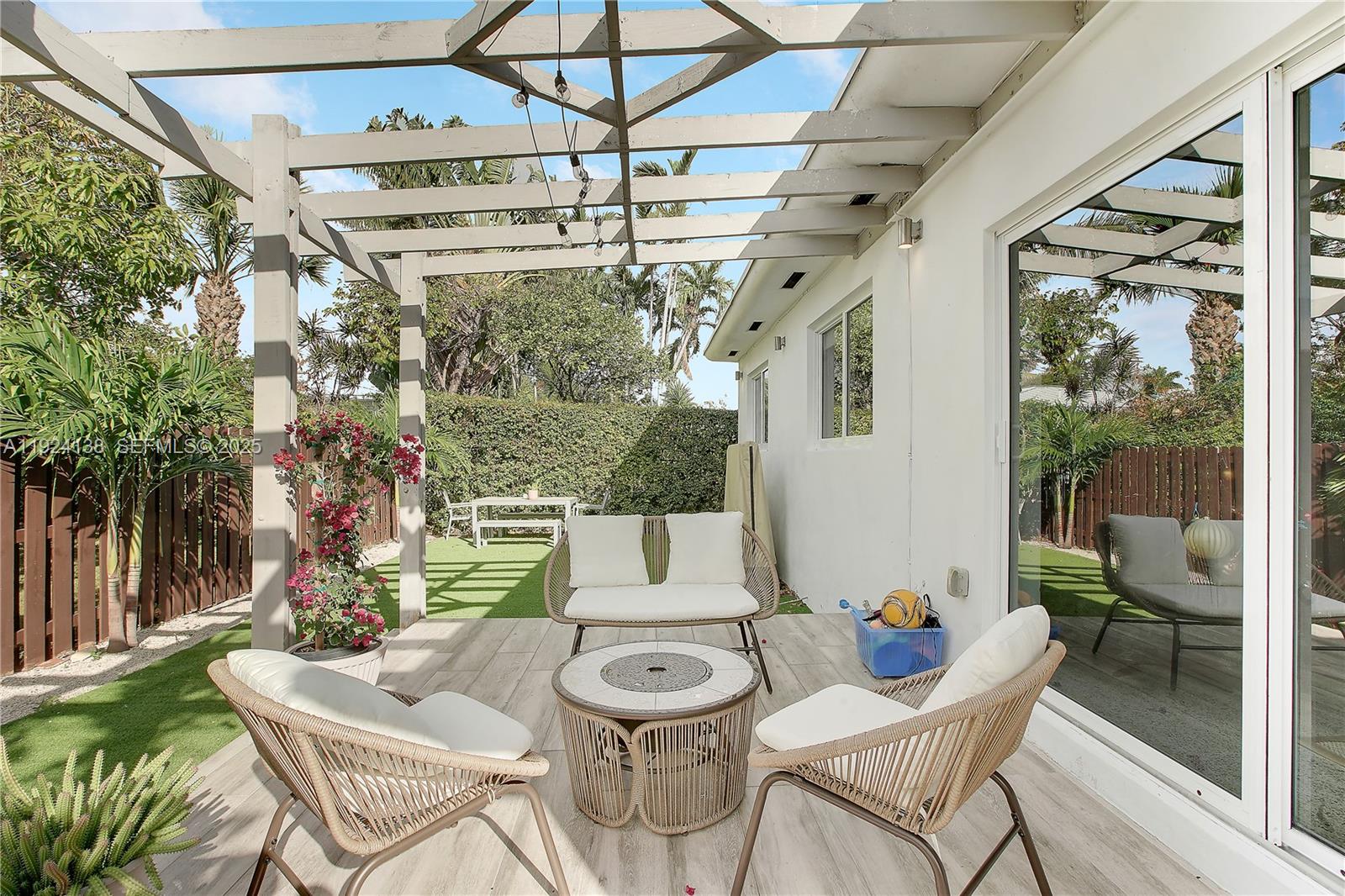 9008 Dickens Avenue Surfside, FL 33154 - Photo 25 of 29 a view of a patio with table and chairs and potted plants