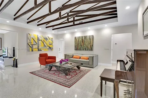 a living room with furniture a rug and a window