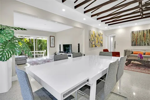 a large white kitchen with a large window