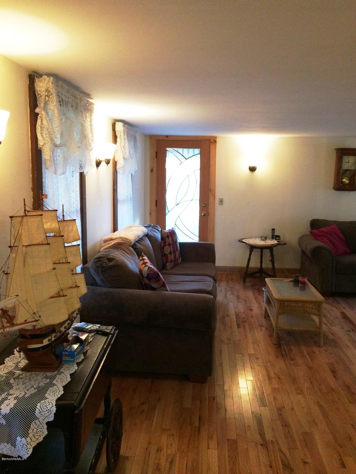 906 South Undermountain Road Sheffield, MA 01257 - Photo 2 of 12 a living room with furniture and a fireplace