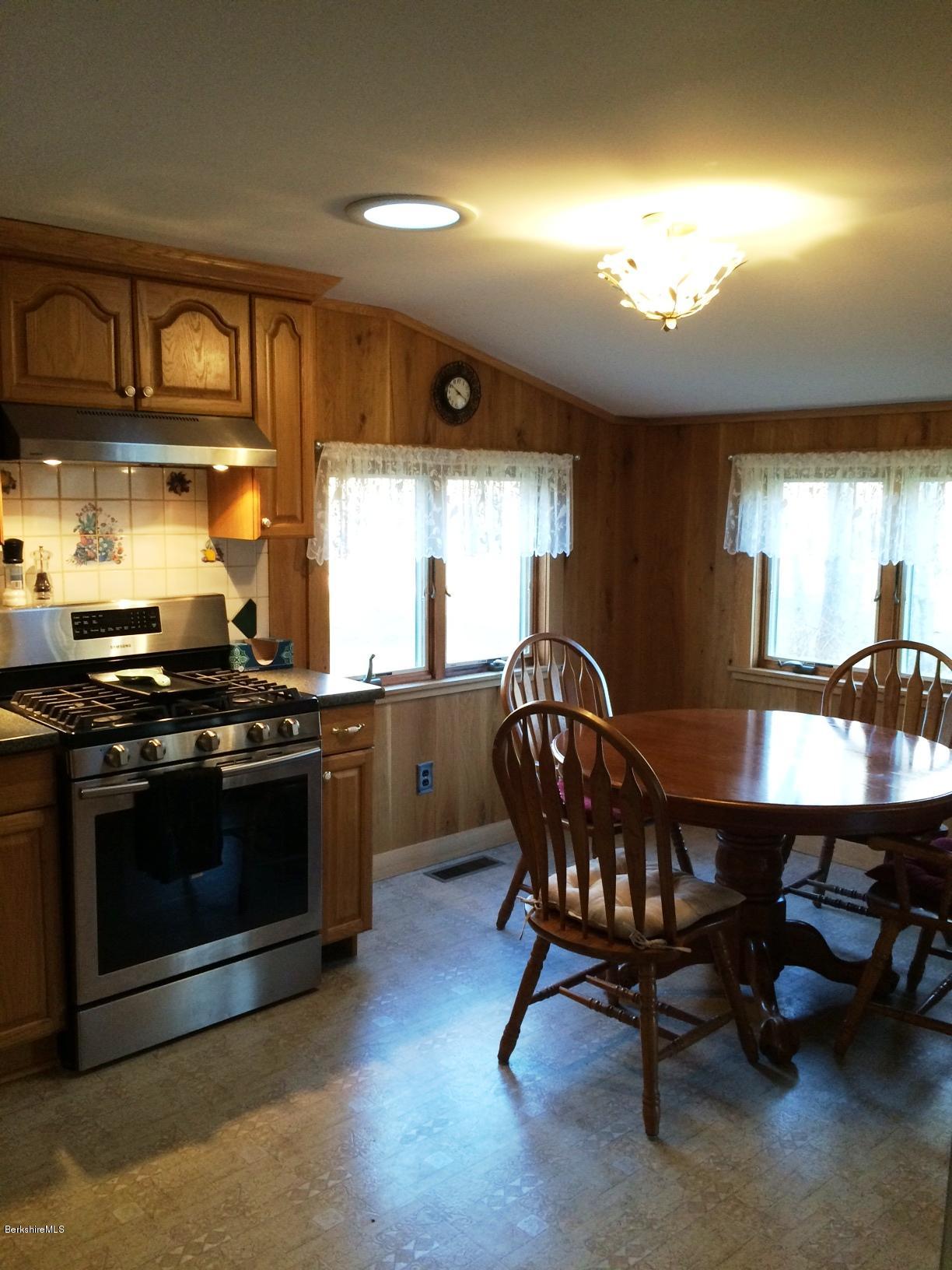 906 South Undermountain Road Sheffield, MA 01257 - Photo 3 of 12 a kitchen with stainless steel appliances granite countertop a stove a sink and a microwave
