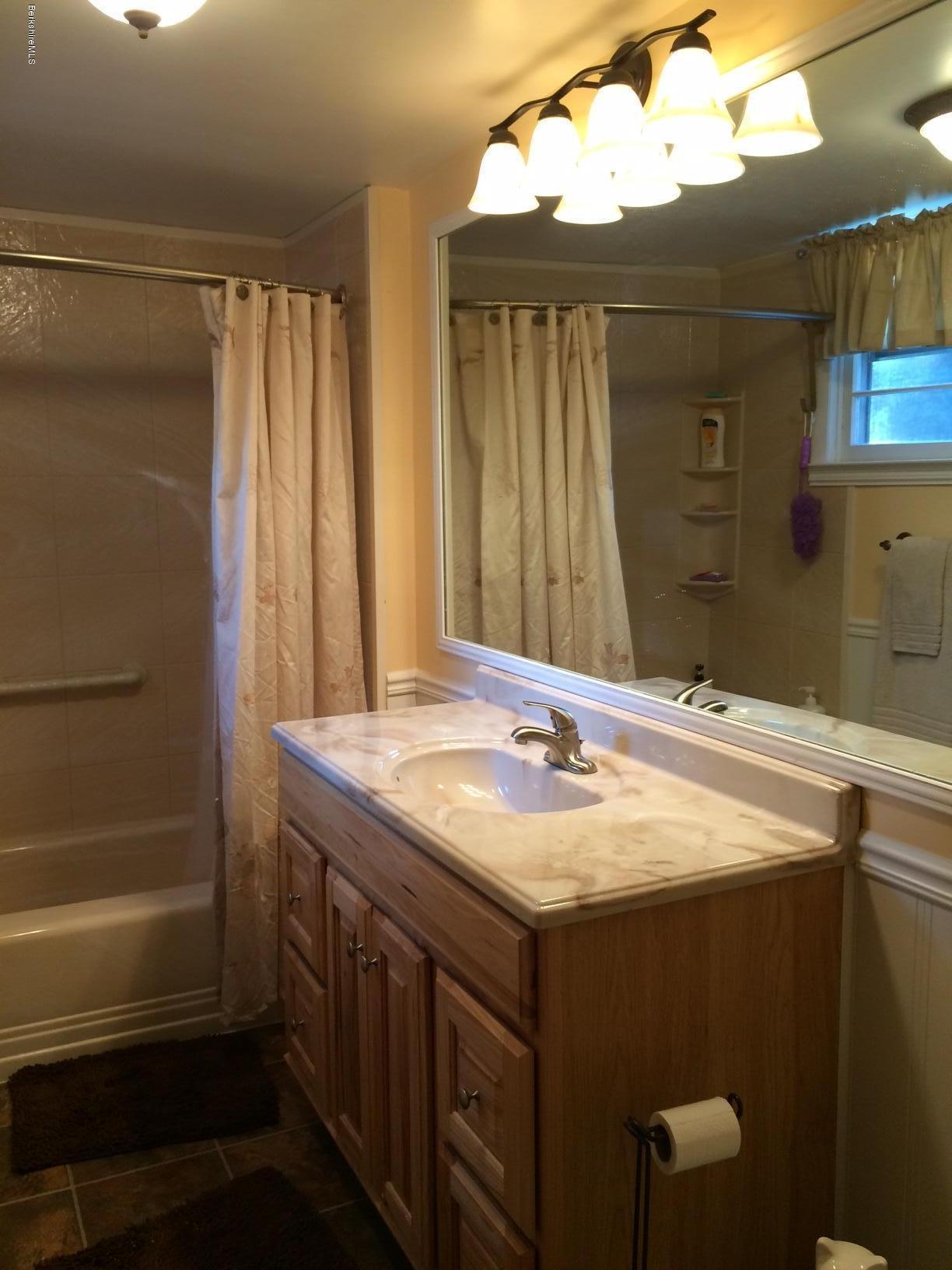 906 South Undermountain Road Sheffield, MA 01257 - Photo 8 of 12 a bathroom with a granite countertop sink and a mirror
