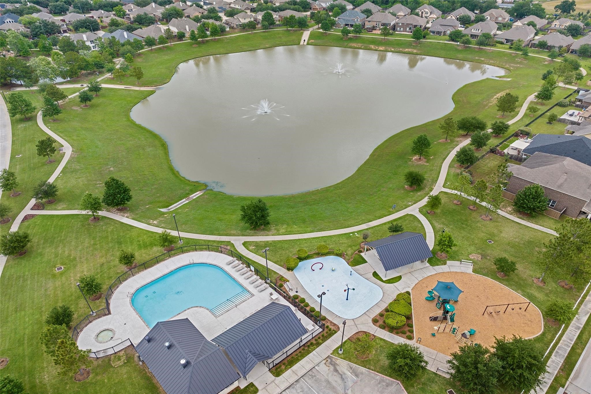 7042 Sliding Rock Circle Spring, TX 77379 - Photo 34 of 36 Discover serene living in Twin Falls Community, featuring picturesque views of the lake, a refreshing pool, and a vibrant playground. Perfect for families seeking tranquility and recreation.