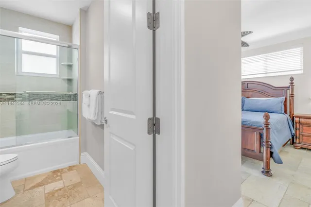 a dining room filled chandelier and kitchen view