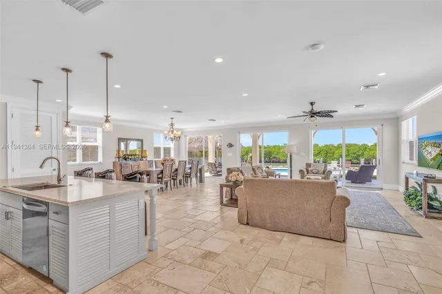 a kitchen with granite countertop cabinets and chairs