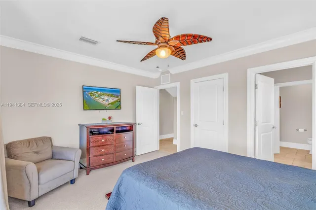 a living room with furniture and a ceiling fan