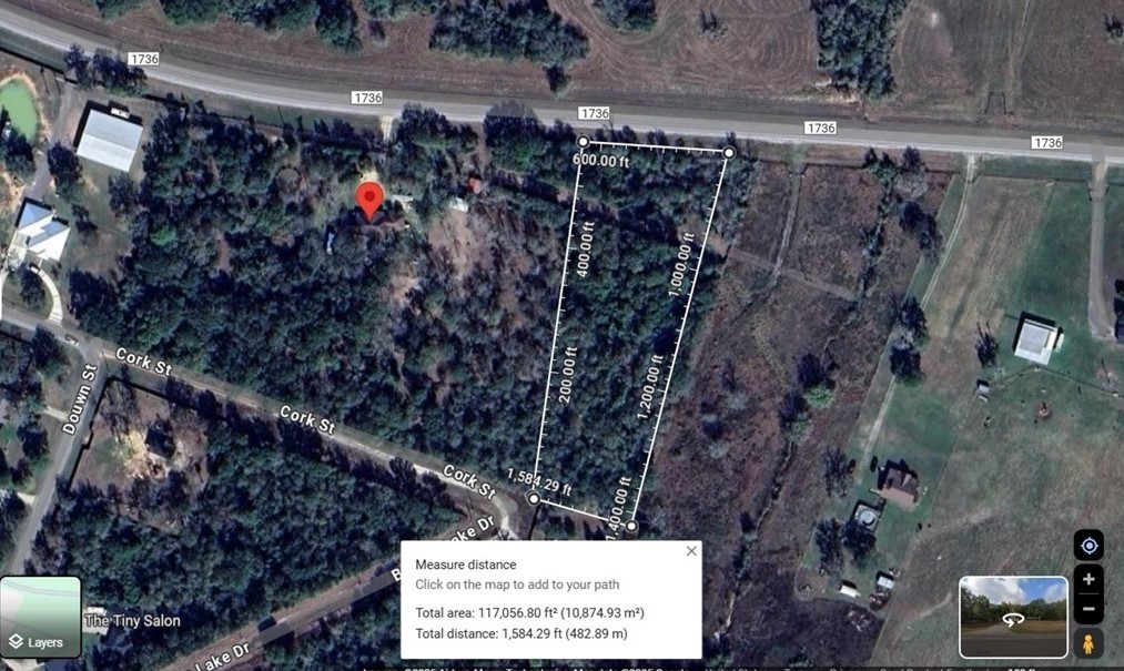 31365 B Fm 1736 Road Hempstead, TX 77445 - Photo 4 of 9 This aerial image shows a rectangular, wooded property located near a main road (1736) and intersecting streets like Cork St and Down St. The outlined area measures approximately 117,056.80 square feet (10,874.93 m²). The land is surrounded by trees, offering privacy, with nearby structures visible.