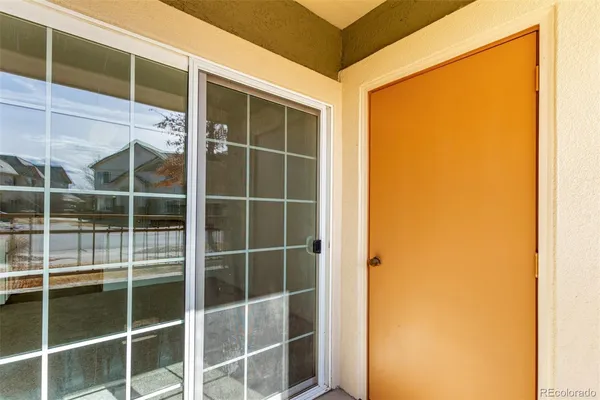 a view of a room with a window and ceiling fan