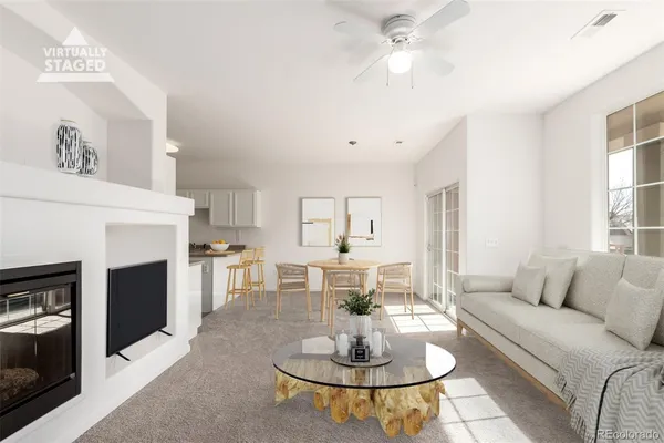 a living room with furniture and a fireplace