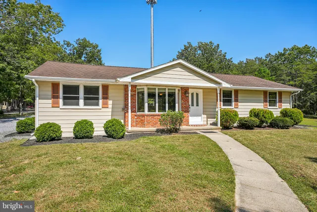 a front view of a house with yard outdoor seating and green space