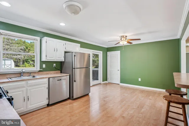 a kitchen with a refrigerator and a sink