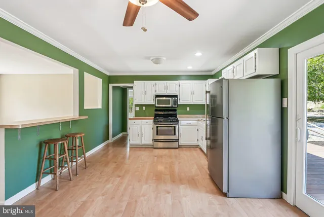 a kitchen with stainless steel appliances a refrigerator and a stove top oven