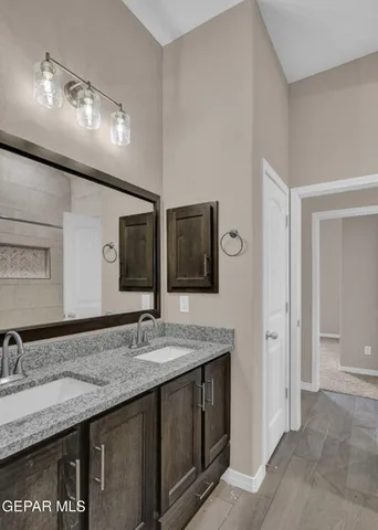 a bathroom with a granite countertop sink toilet a large mirror and shower