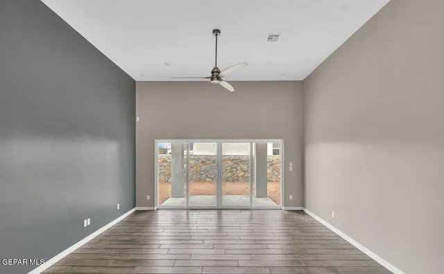 wooden floor in an empty room with a window