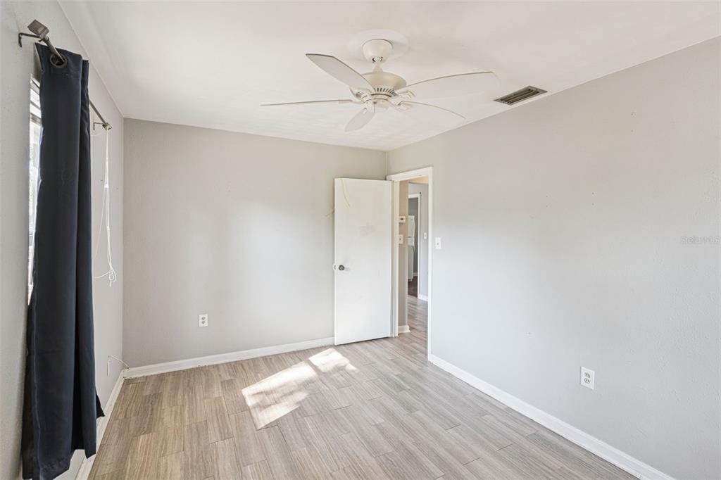 420 Euclid Avenue, Unit 1 Leesburg, FL 34748 - Photo 11 of 18 a view of a room with wooden floor and white walls