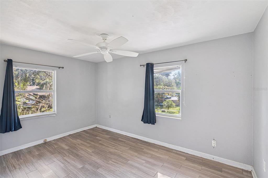 420 Euclid Avenue, Unit 1 Leesburg, FL 34748 - Photo 12 of 18 a view of an empty room with window and wooden floor