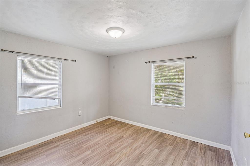 420 Euclid Avenue, Unit 1 Leesburg, FL 34748 - Photo 13 of 18 a view of an empty room with wooden floor and a window