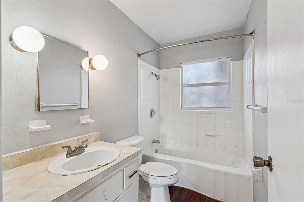 420 Euclid Avenue, Unit 1 Leesburg, FL 34748 - Photo 14 of 18 a bathroom with a granite countertop sink toilet and shower