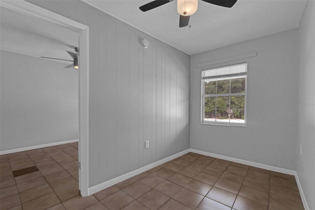 420 Euclid Avenue, Unit 1 Leesburg, FL 34748 - Photo 17 of 18 an empty room with windows and chandelier fan