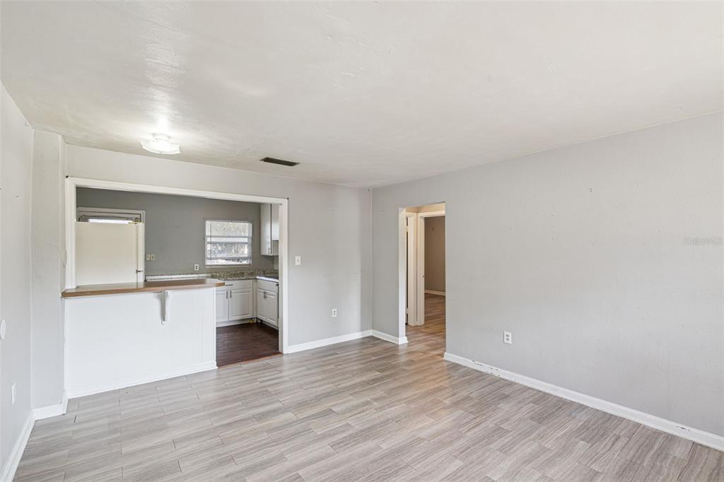 420 Euclid Avenue, Unit 1 Leesburg, FL 34748 - Photo 6 of 18 a view of a kitchen with wooden floor and a window
