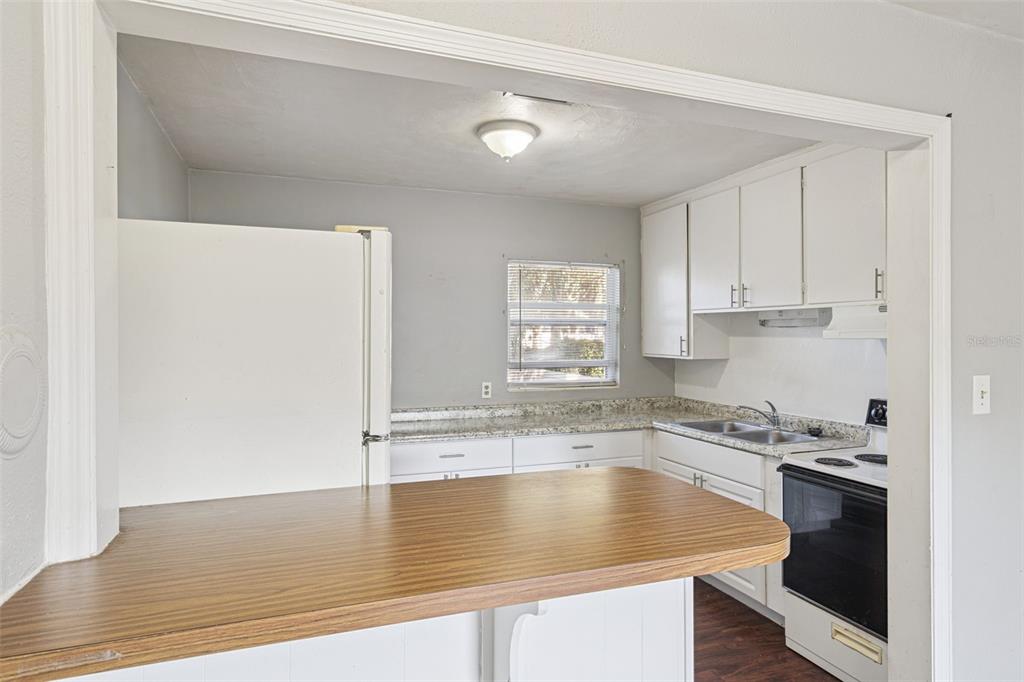 420 Euclid Avenue, Unit 1 Leesburg, FL 34748 - Photo 10 of 18 a kitchen with a sink a stove and cabinets