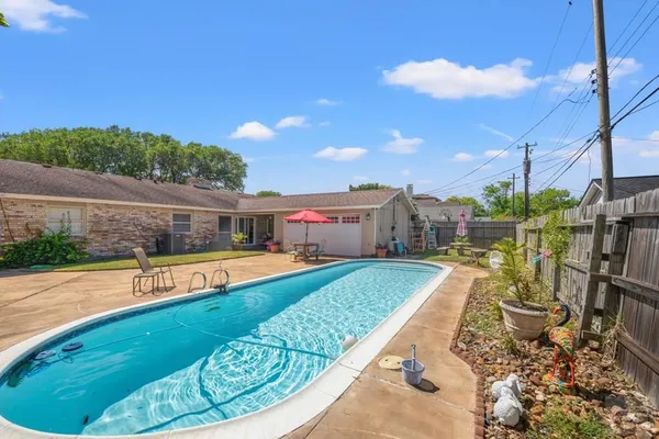a view of a swimming pool with a lounge chairs