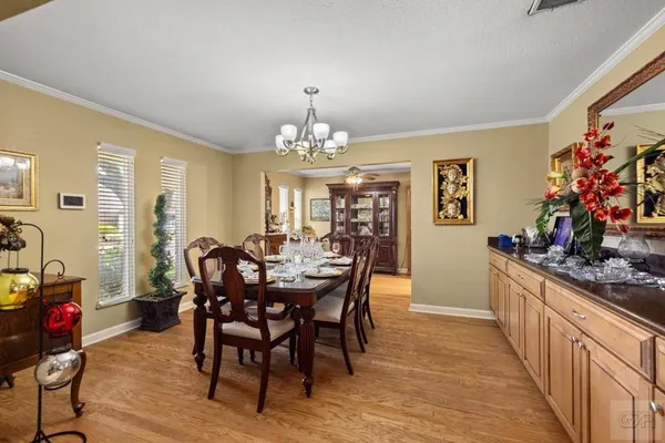 a view of a dining room with furniture and chandelier