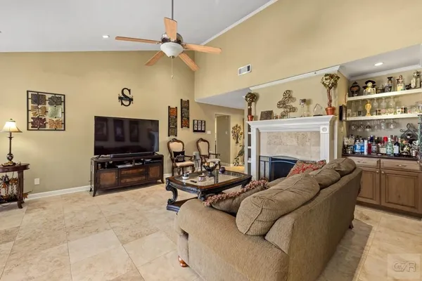 a living room with fireplace furniture and a flat screen tv