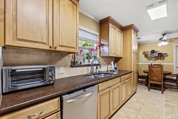 a kitchen with appliances a sink and cabinets