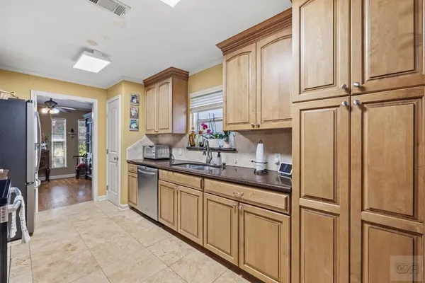 a kitchen with stainless steel appliances a sink and cabinets