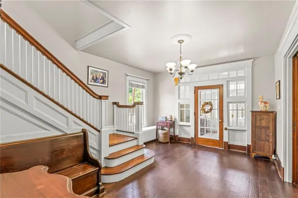a living room with furniture and a chandelier