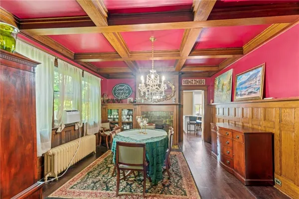 a dining room with furniture a rug and a floor to ceiling window