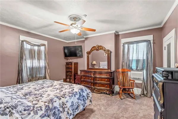 a bedroom with furniture and a flat screen tv