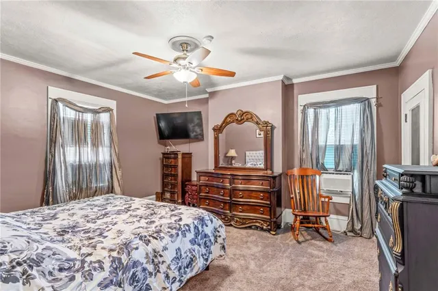 a bedroom with furniture and a flat screen tv