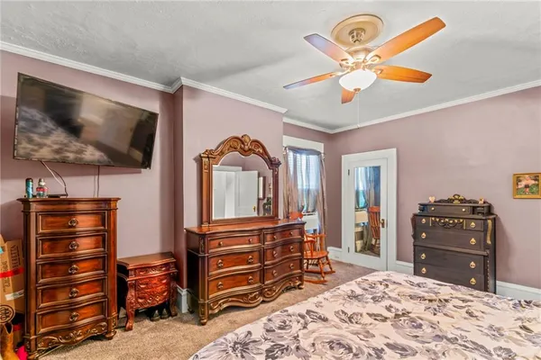 a bedroom with a bed and a television