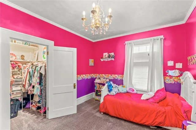 a bed room with a bed and a chandelier