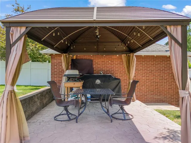 a view of a chairs and table in the patio
