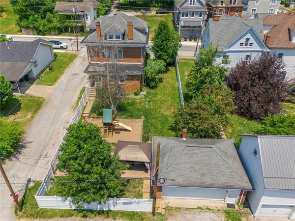 an aerial view of a house with swimming pool and garden