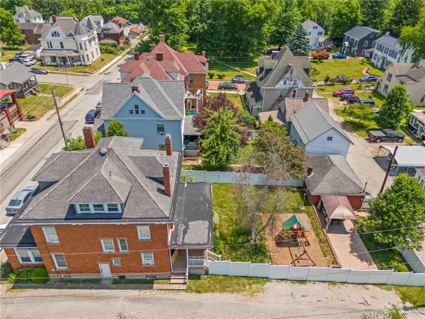 an aerial view of residential houses with yard