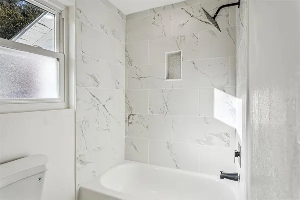 a bathroom with a bathtub and a shower