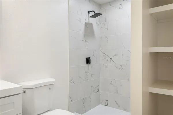 a bathroom with a toilet and shower