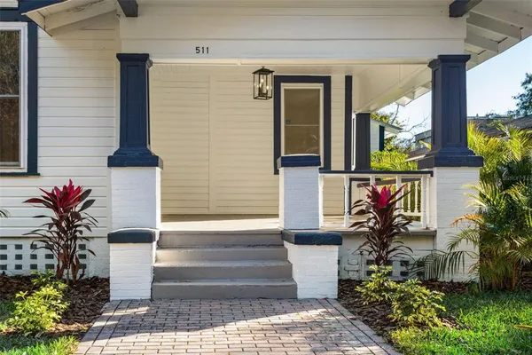 a front view of a house with a garden