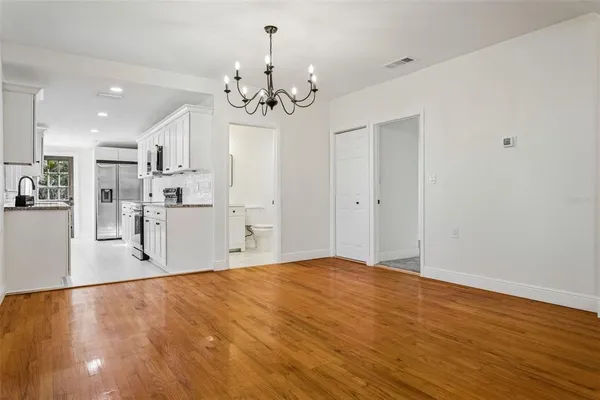 a view of a kitchen with stainless steel appliances a chandelier